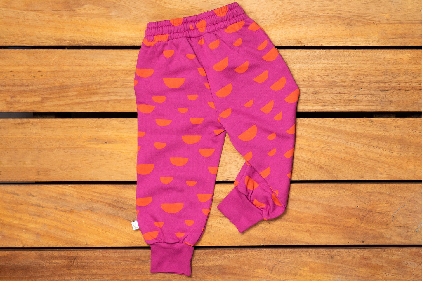 jogging pour enfant chaud rose avec des motifs oranges